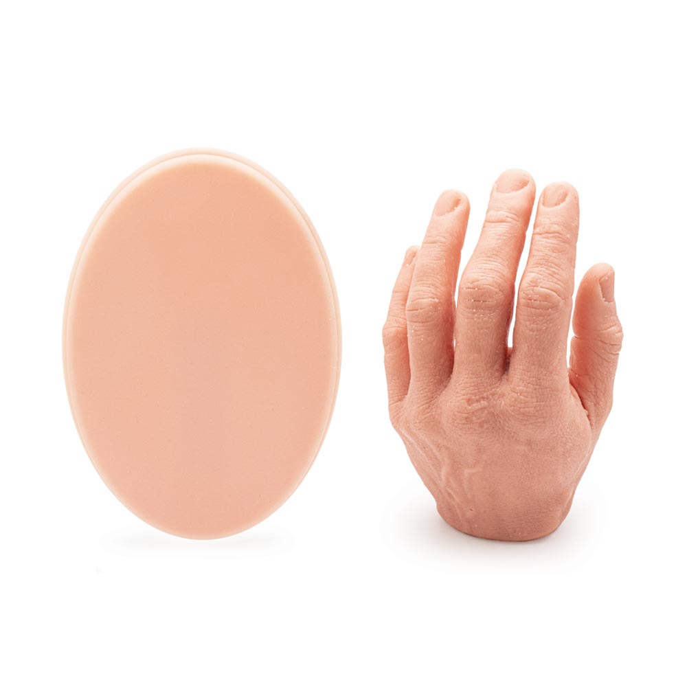 A Pound of Flesh Micro Series Tattooable Synthetic Small Oval (with hand for scale)